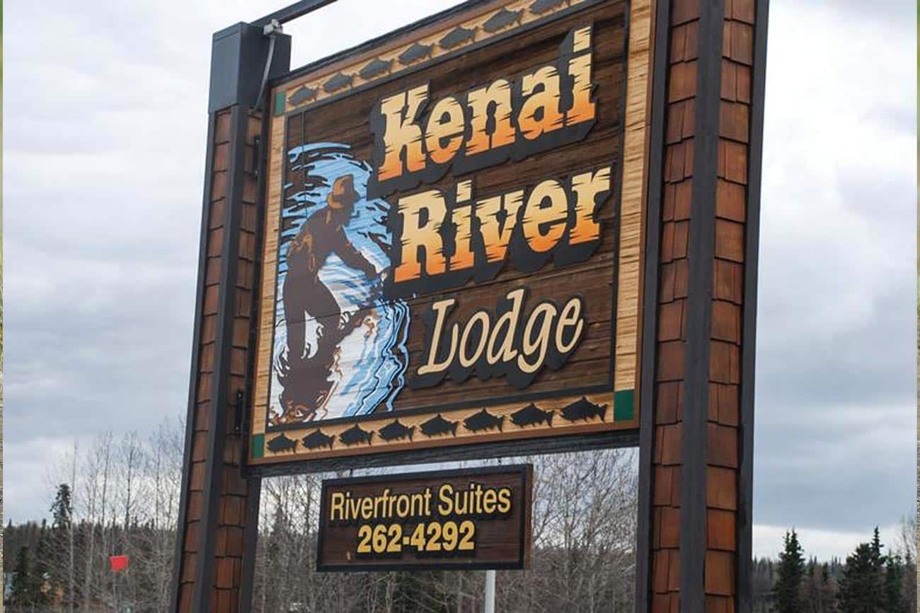 Kenai River Lodge street sign with phone number